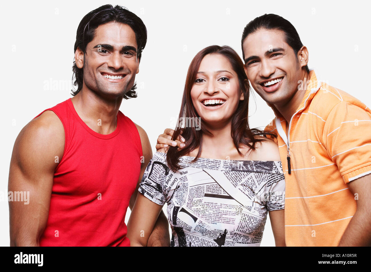 Portrait of two young men and a young woman smiling Stock Photo - Alamy