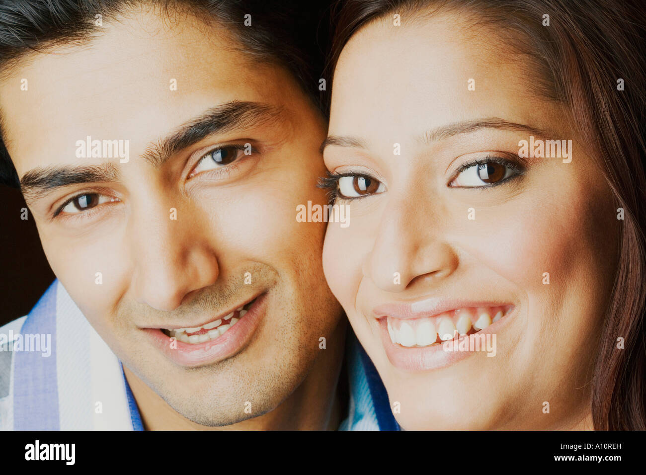 Portrait of a young couple smiling Stock Photo - Alamy
