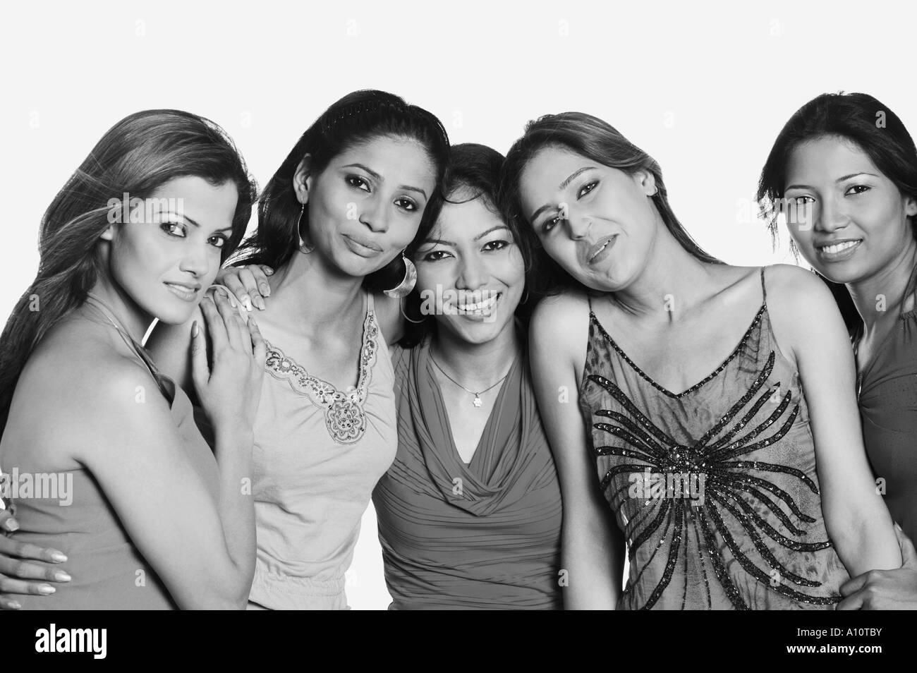 Portrait of five young women standing together and smiling Stock Photo