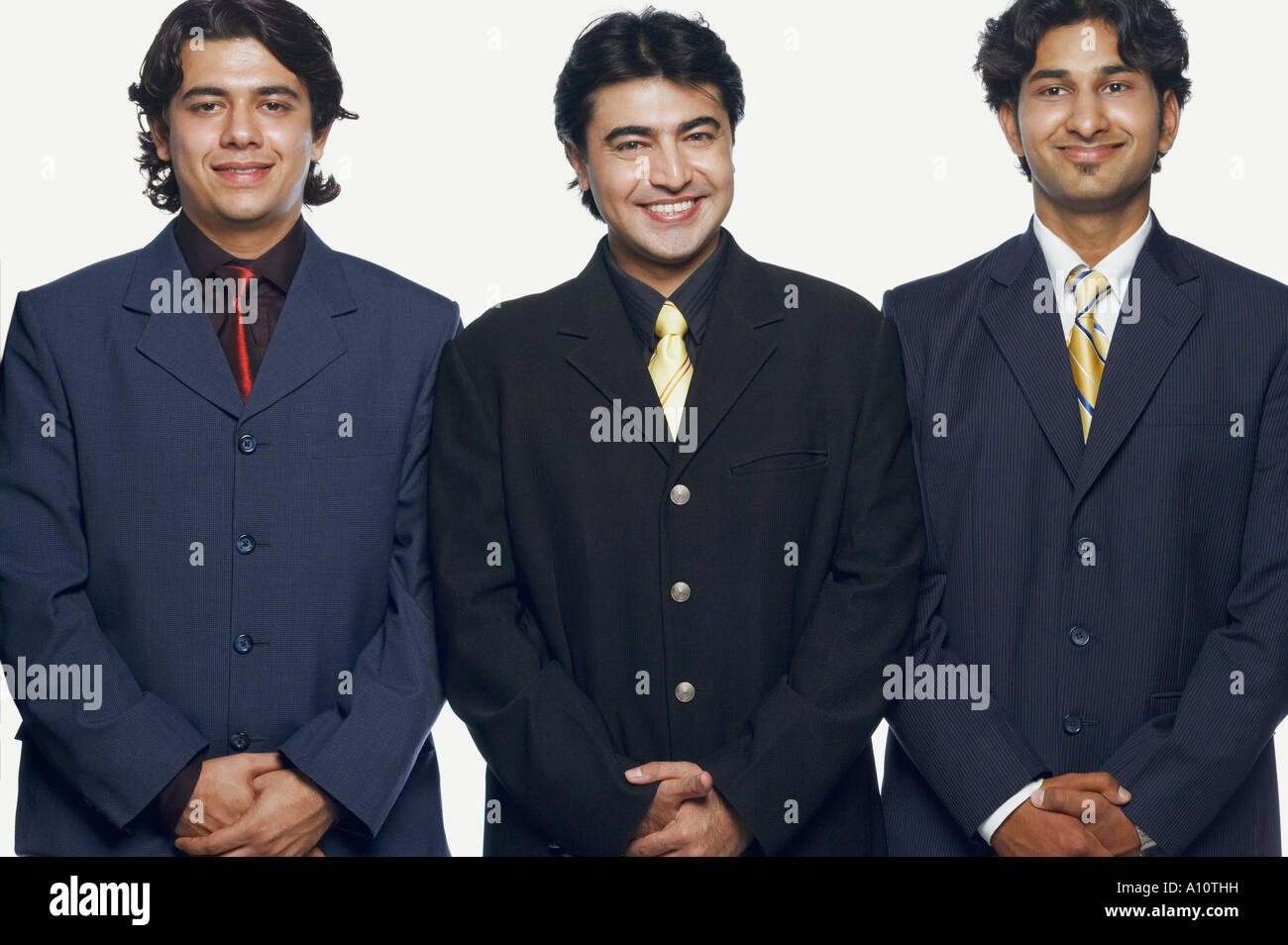 Portrait of three businessmen standing side by side and smiling Stock ...
