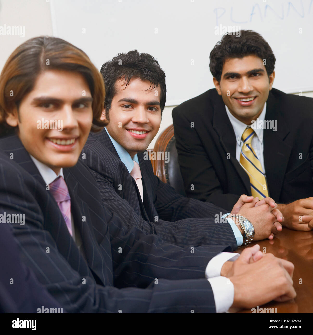 Portrait of three businessmen smiling Stock Photo - Alamy