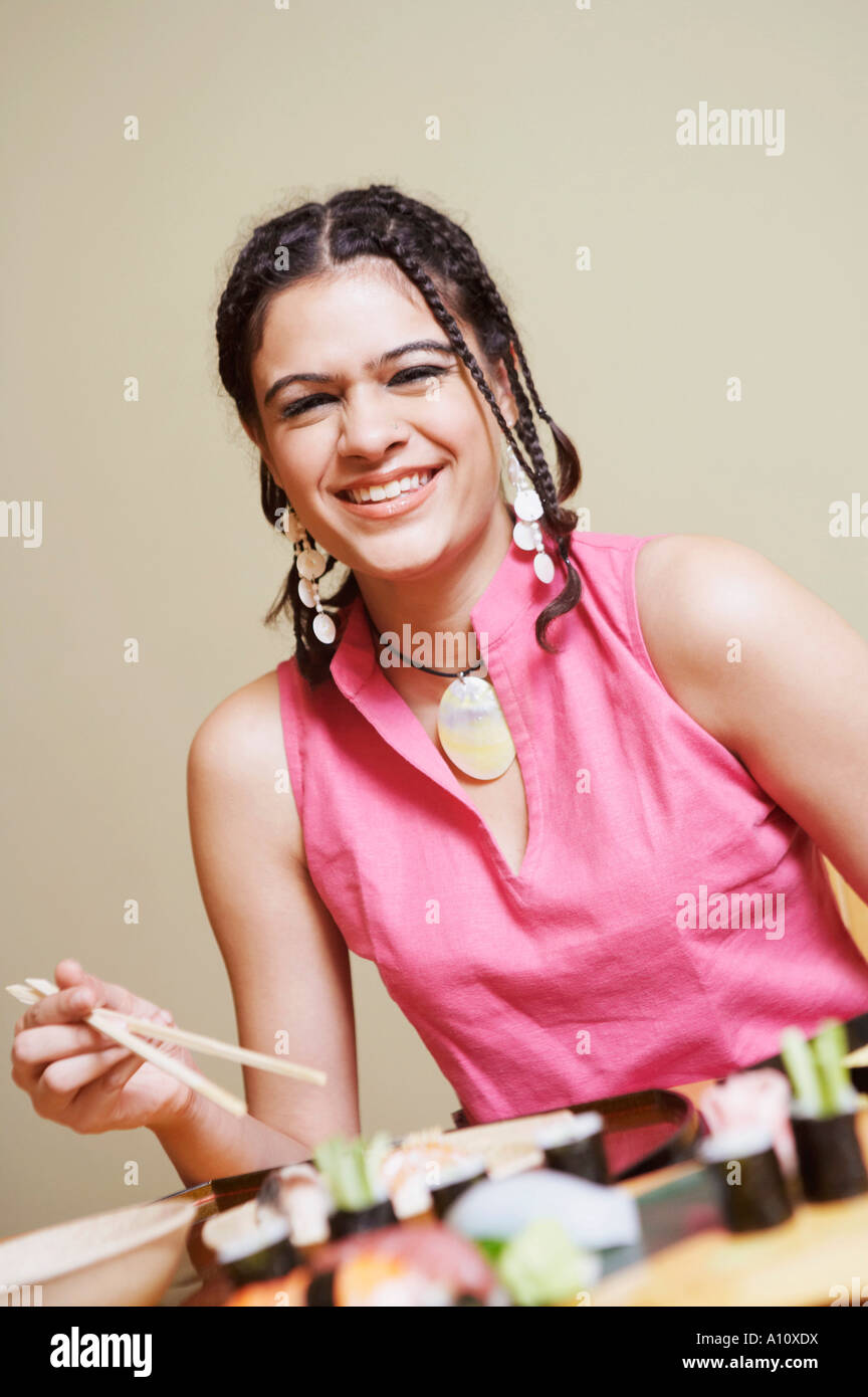 Portrait of a young woman sitting at the dining table and smiling Stock ...