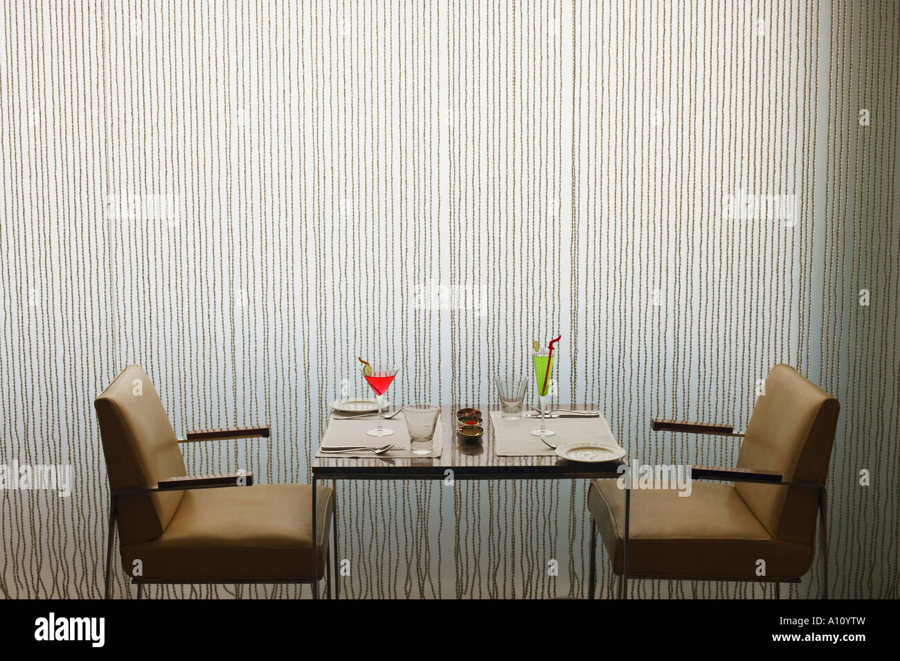 Closeup of two empty chairs and a table in a restaurant Stock Photo