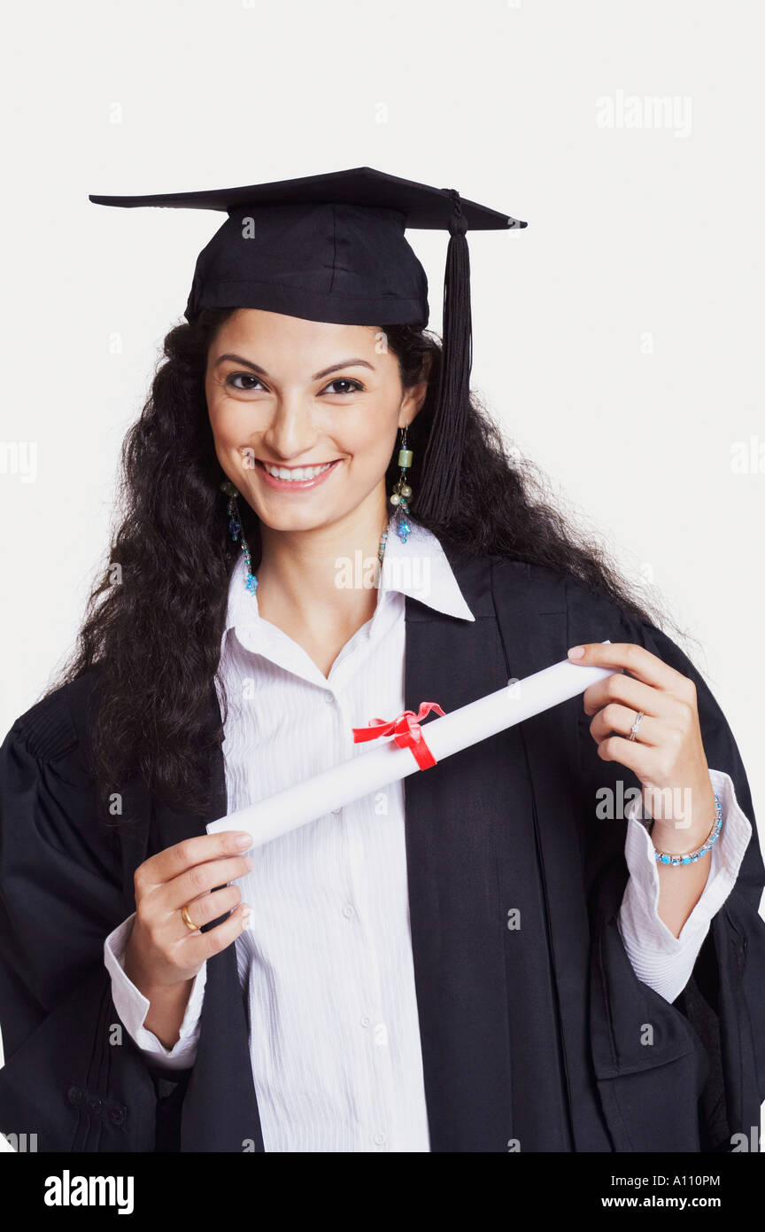 Portrait of a female graduate holding a diploma and smiling Stock Photo ...