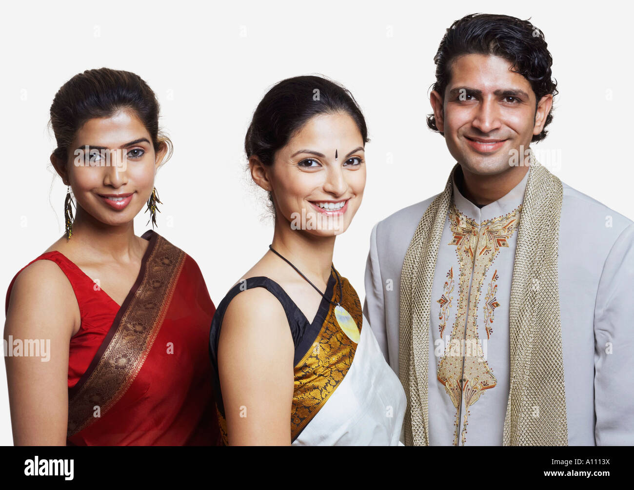 Portrait of a young man standing and smiling with two young women Stock ...