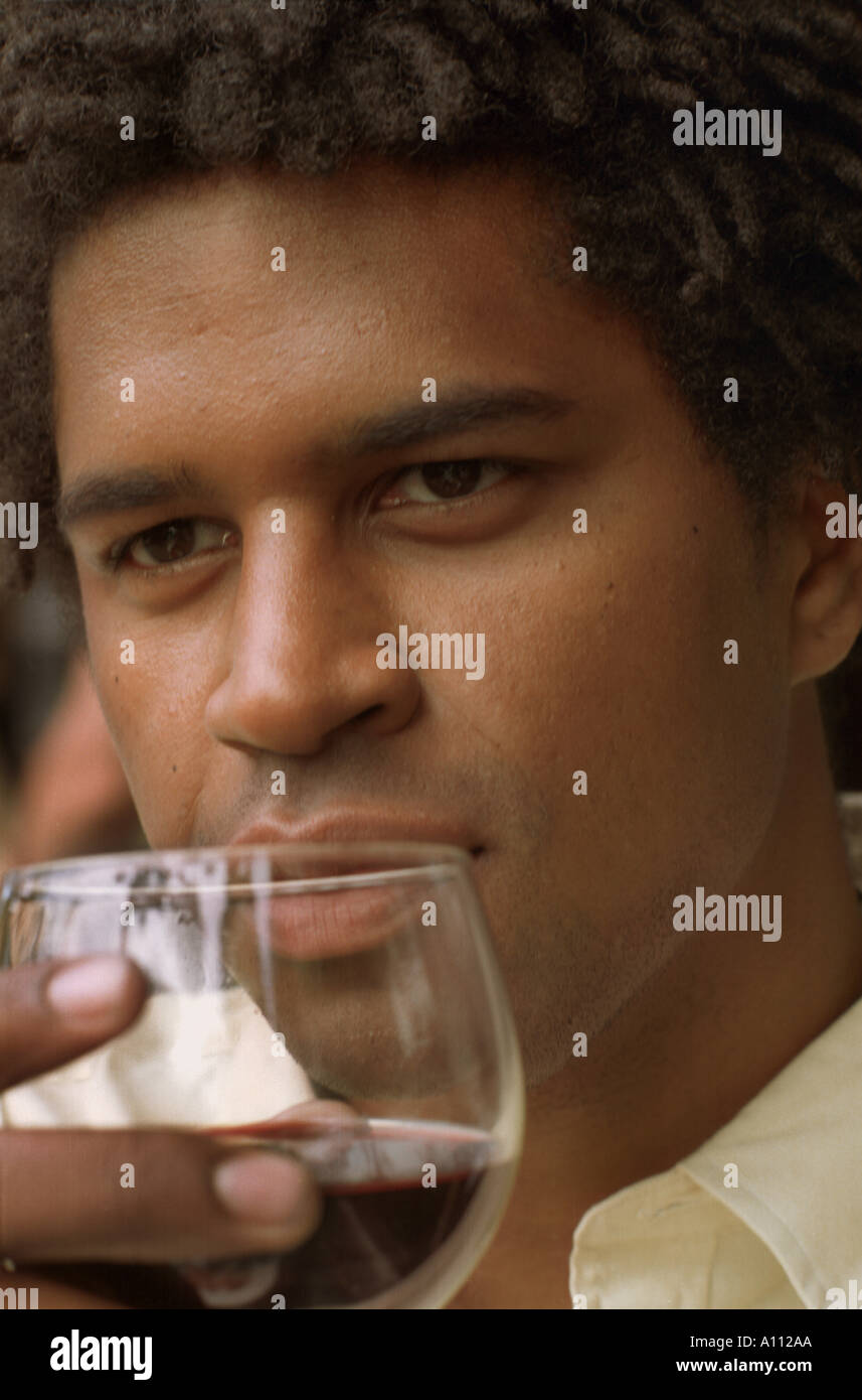 A young African American man drinking red wine Stock Photo Alamy