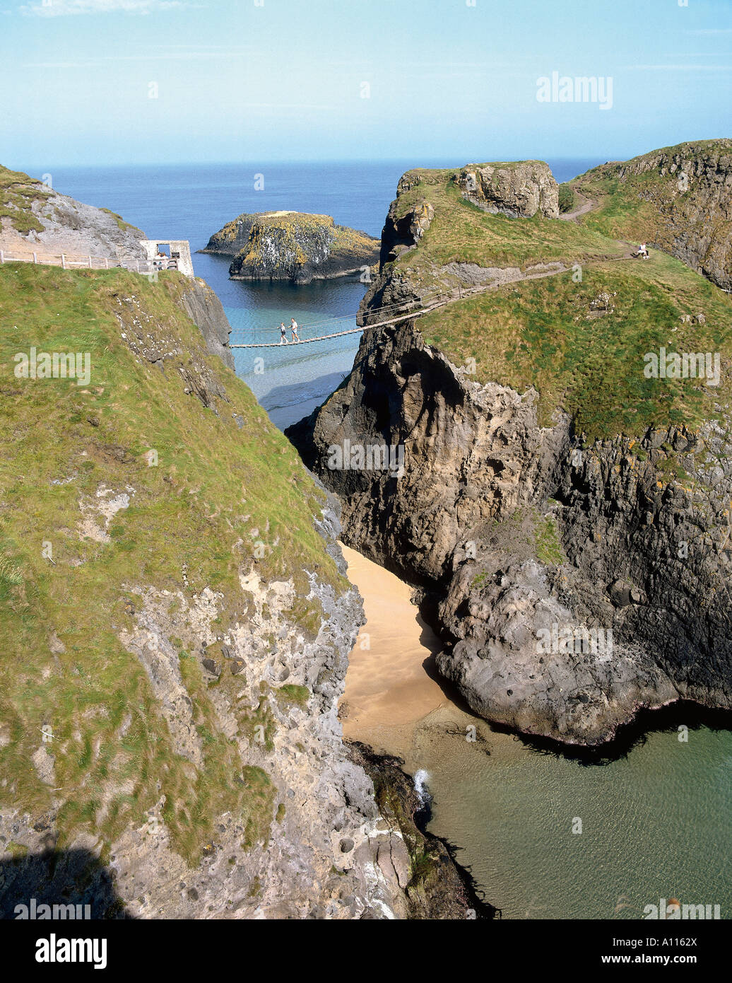The Carrick a rede or passage of the salmon is separated from the mainland by a chasm A frail bridge hangs across and promises to unsettle even the bravest of passengers Stock Photo