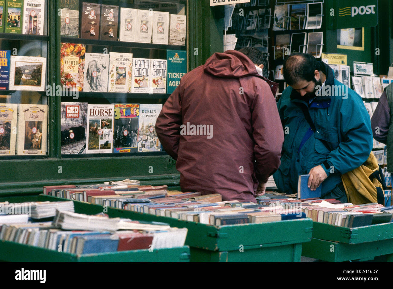 People browse through a stall selling second hand books at Greens
