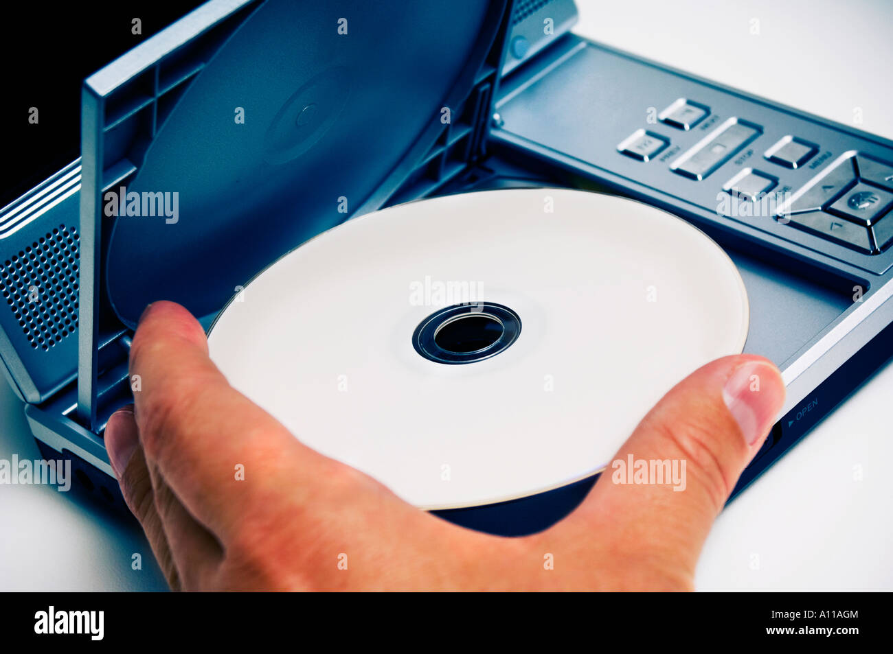 Man putting DVD into player Stock Photo Alamy