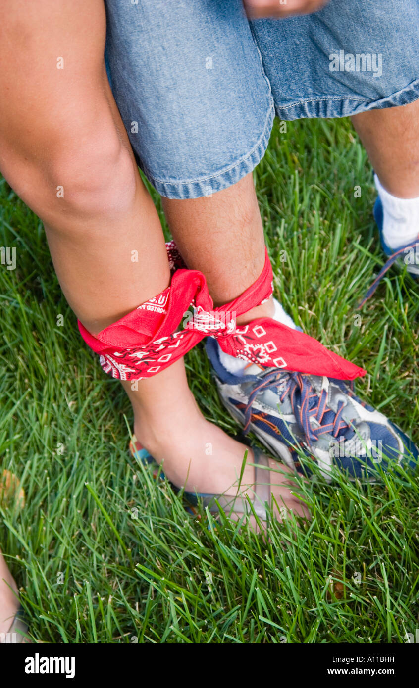 Kids having a one legged race Stock Photo - Alamy