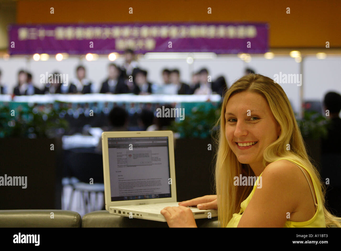 Student taking notes on a laptop computer at a University seminar Stock Photo