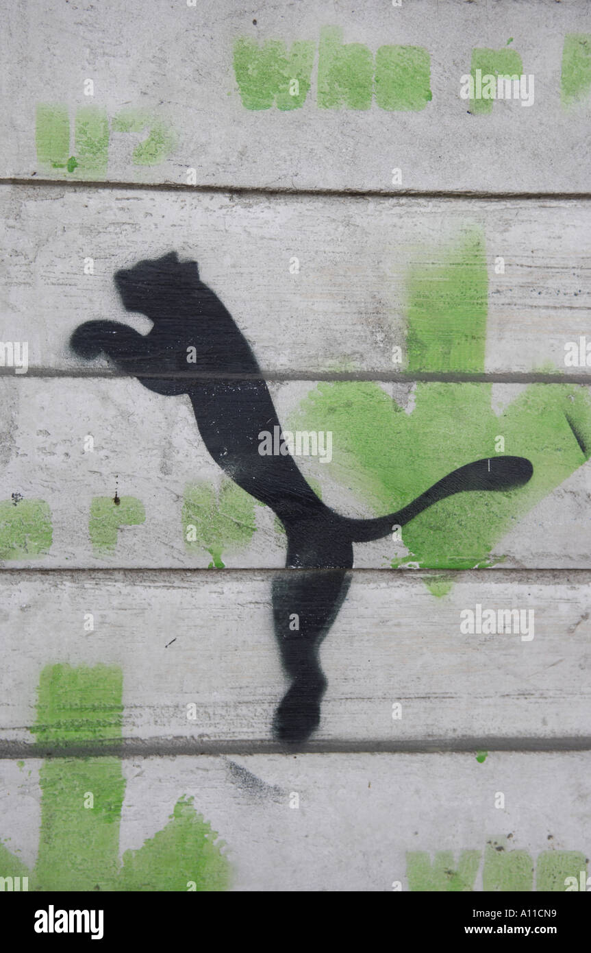 puma stencil art graffiti spraypaint walll concrete manchester vertical  blakc green grey colour color Stock Photo - Alamy