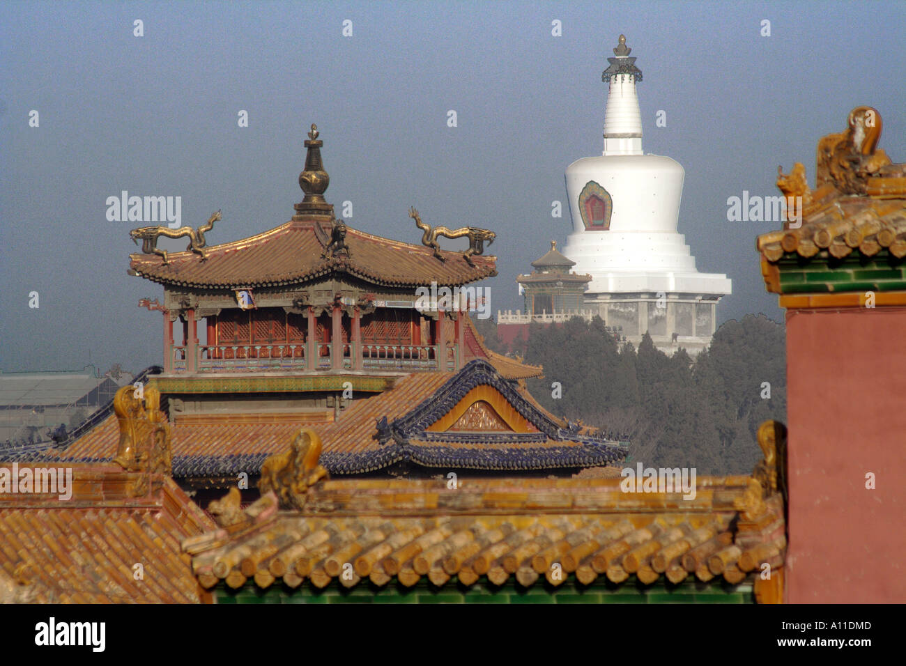 Rooftops and towers of the Forbidden City with the Baitai White Dagoba in the  background, Beijing, China Stock Photo