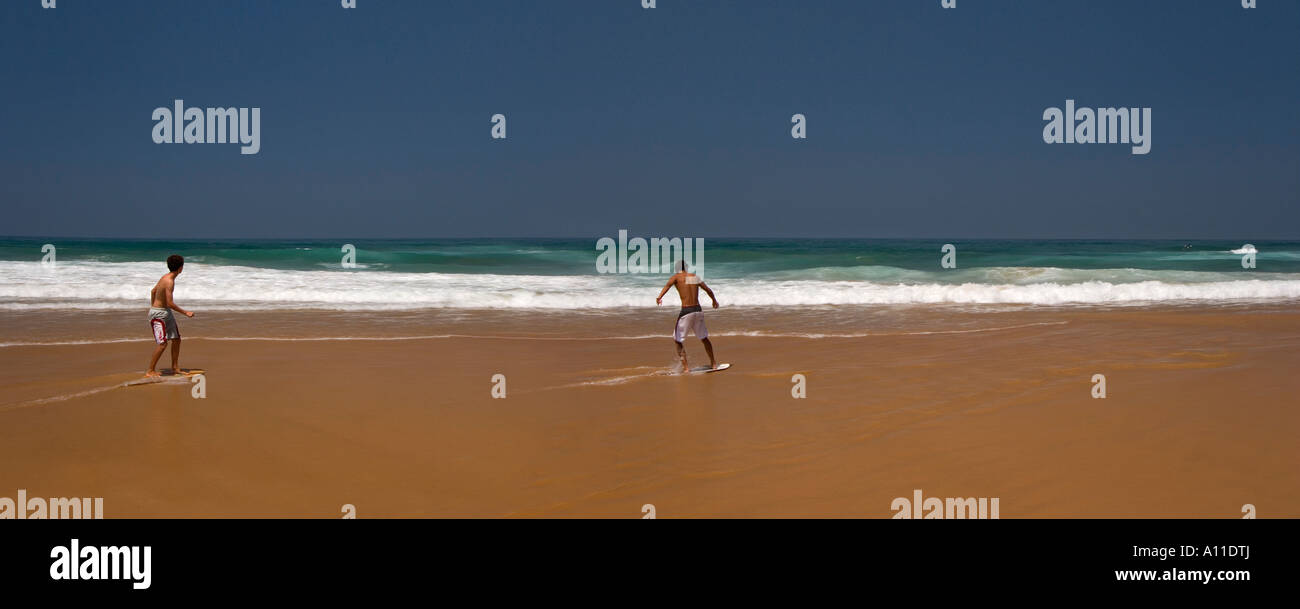 Skimboarders on Cordoama beach, in Algarve (Portugal).  Skimboarder sur la plage de Cordoama, en Algarve (Portugal). Stock Photo