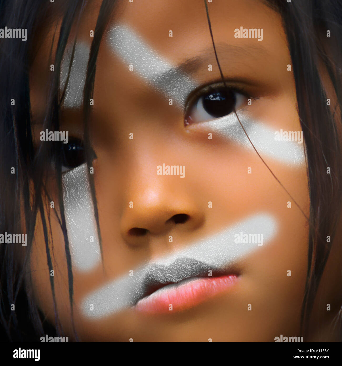 An Asian girl having made up her face. Fillette asiatique au visage décoré. Stock Photo