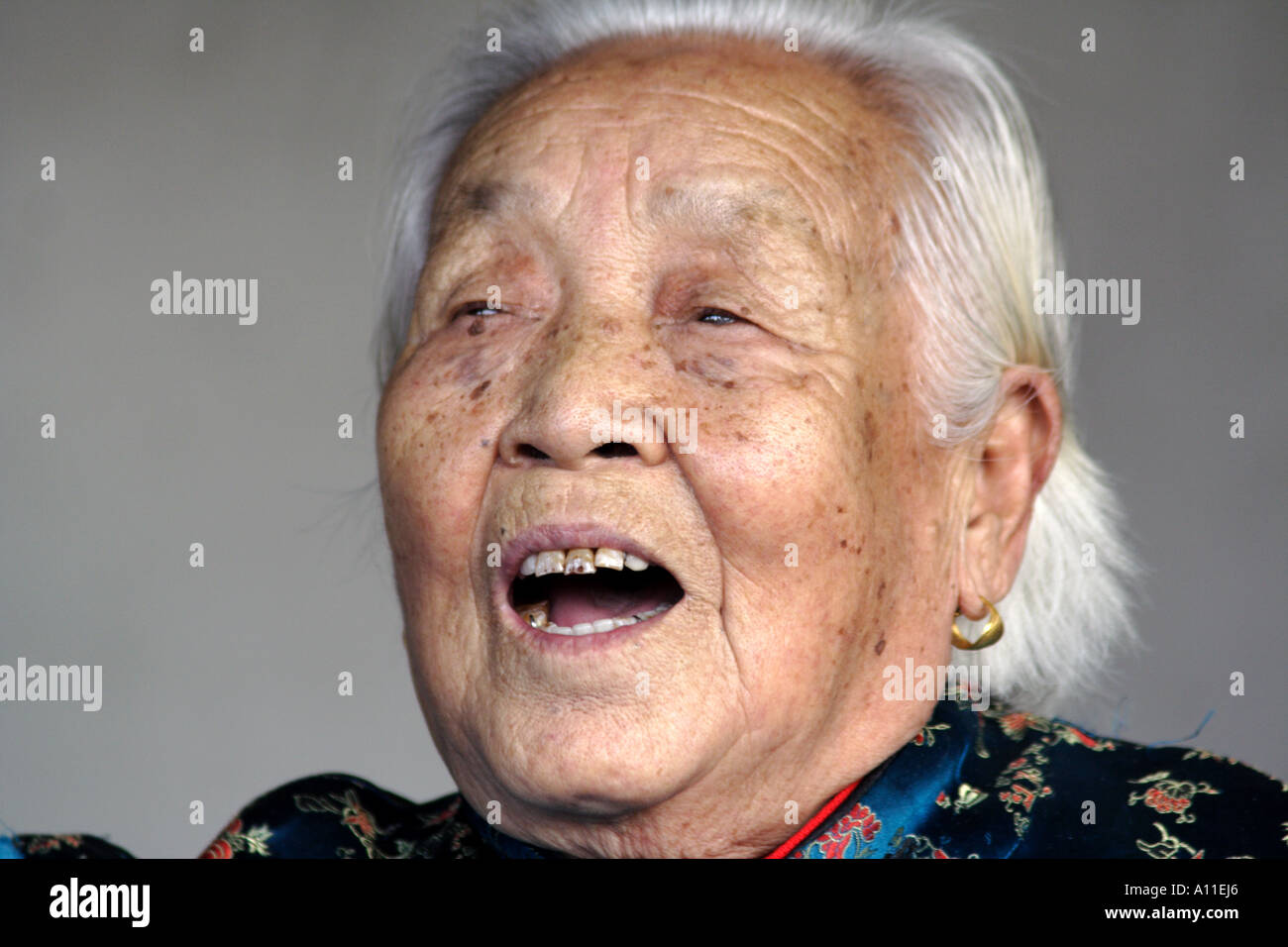 Old woman singing a traditional song to an audience in Temple of Heaven