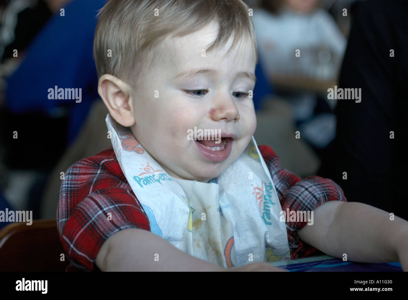 toddler eating wit bib on caucasians white families family home learn