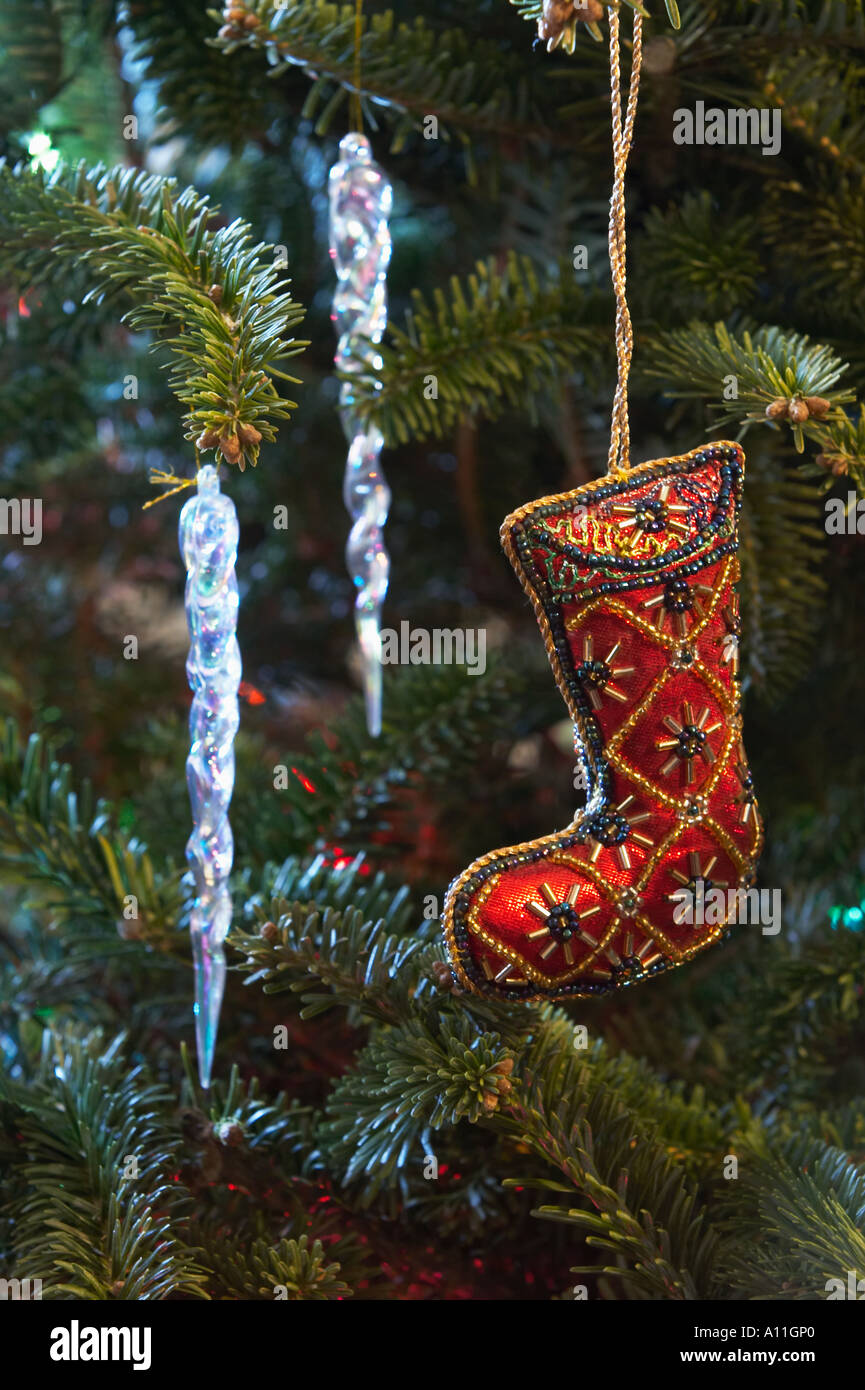 Christmas ornaments hanging on a decorated Christmas tree Stock Photo