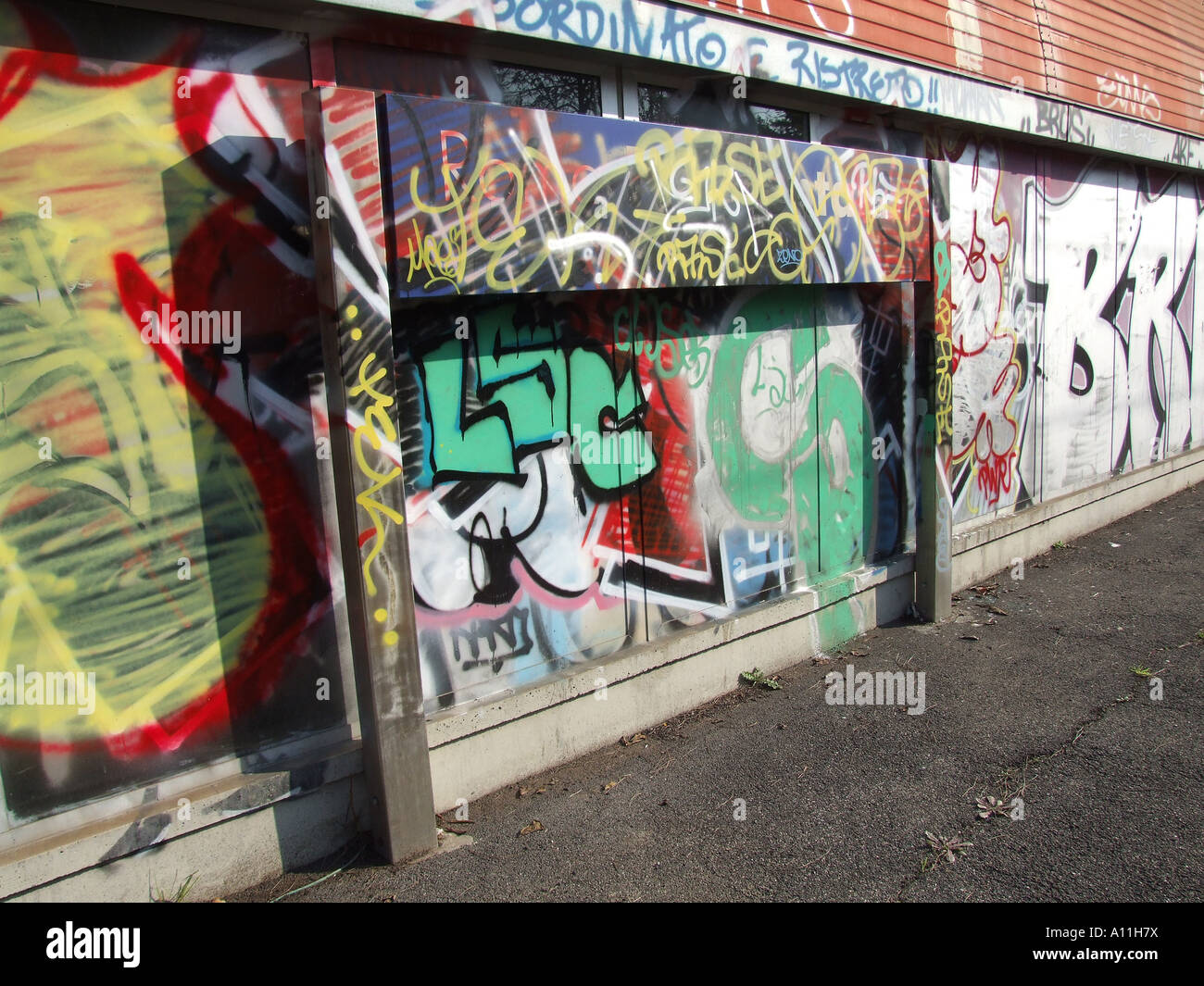 name plate board covered with graffiti in train station in rome Stock ...