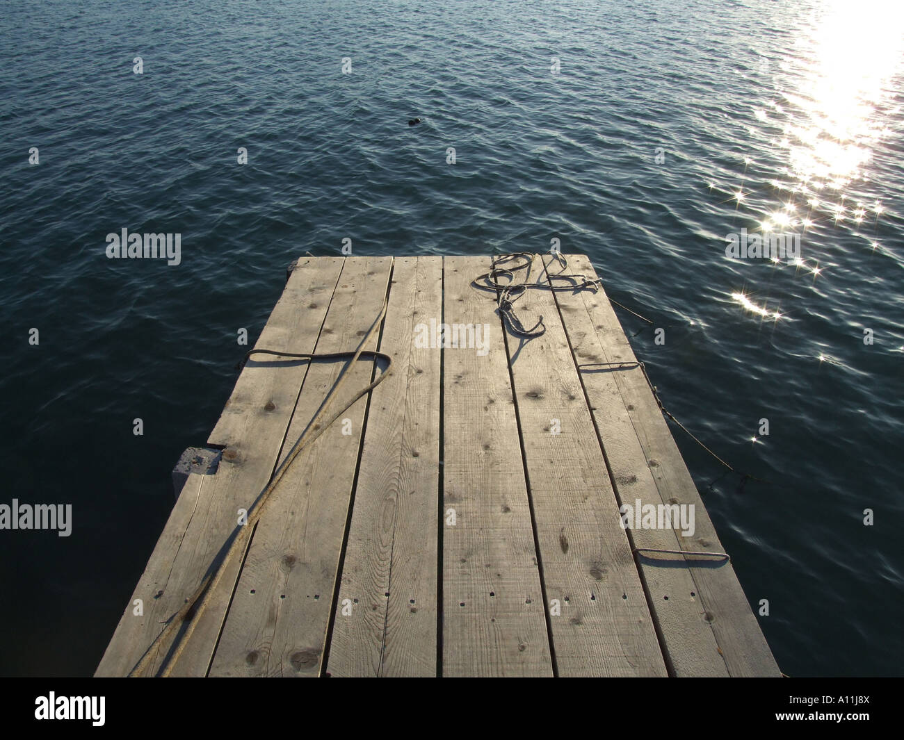 mooring ropes on small jetty by sea Stock Photo - Alamy