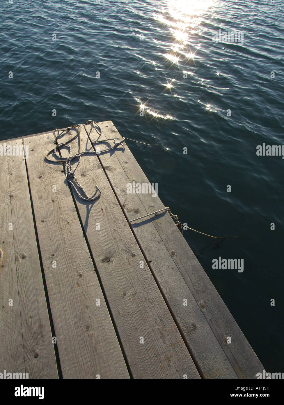 mooring ropes on small jetty by sea Stock Photo - Alamy