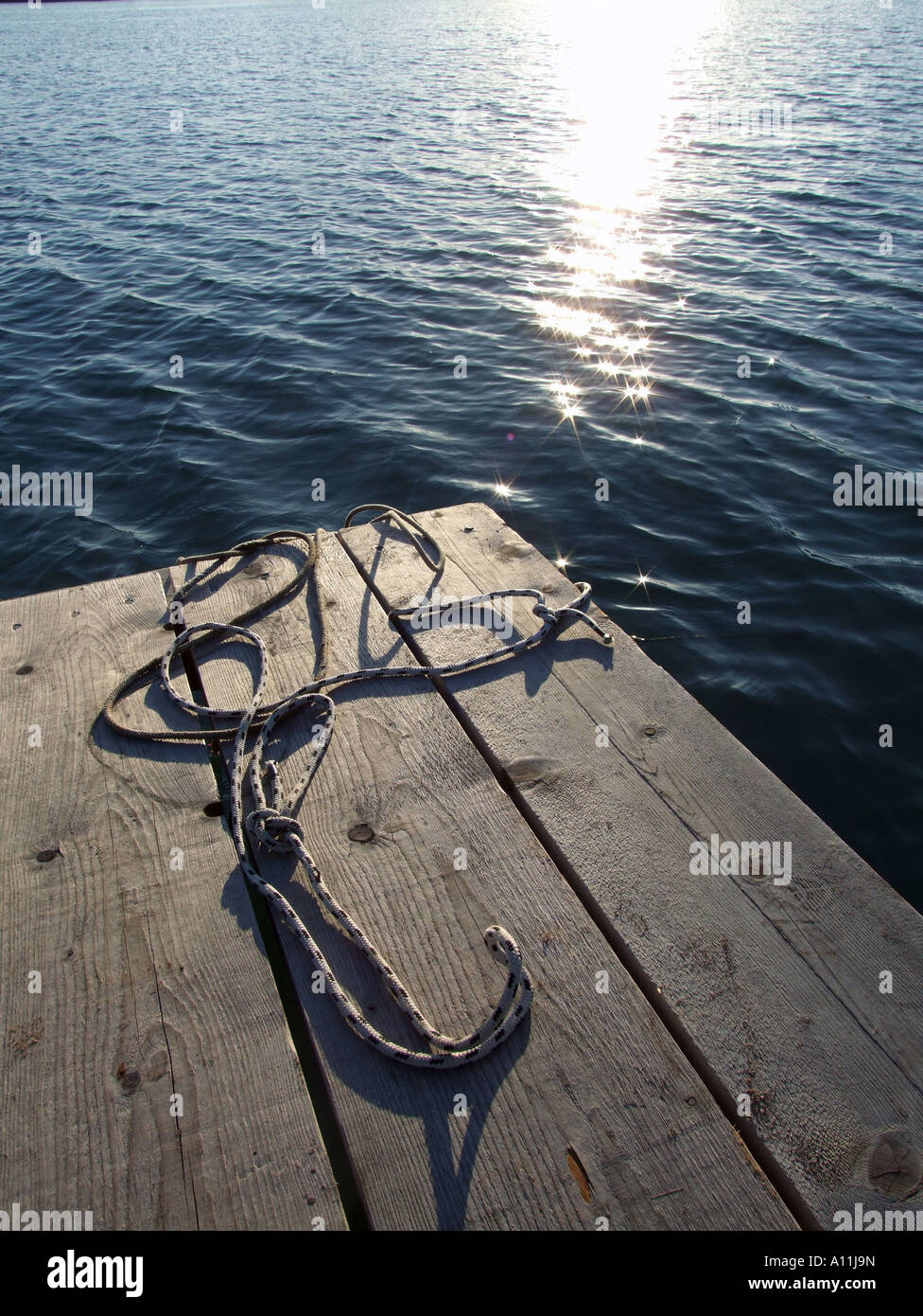mooring ropes on small jetty by sea Stock Photo - Alamy