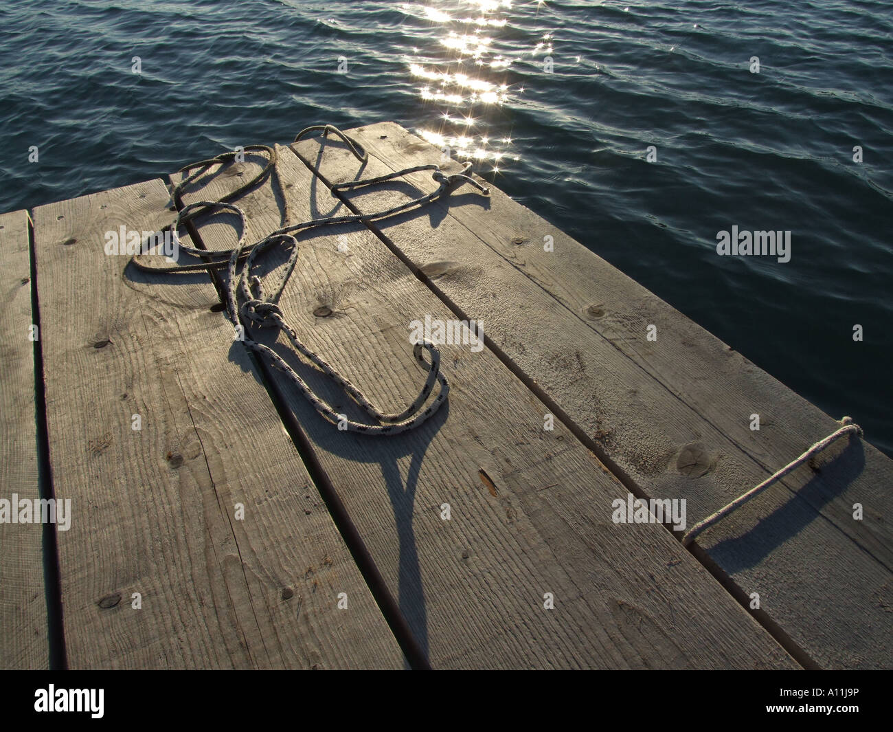 mooring ropes on small jetty by sea Stock Photo - Alamy