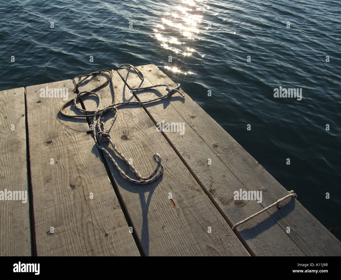 mooring ropes on small jetty by sea Stock Photo - Alamy