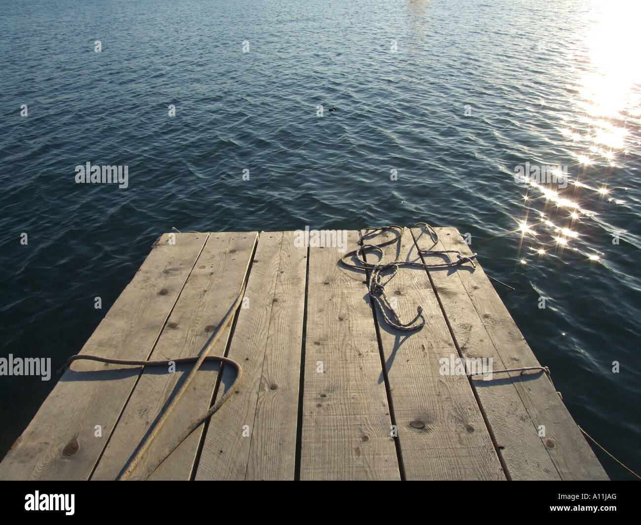 mooring ropes on small jetty by sea Stock Photo - Alamy