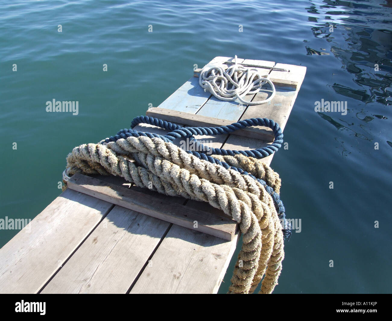mooring ropes on small jetty by sea Stock Photo - Alamy