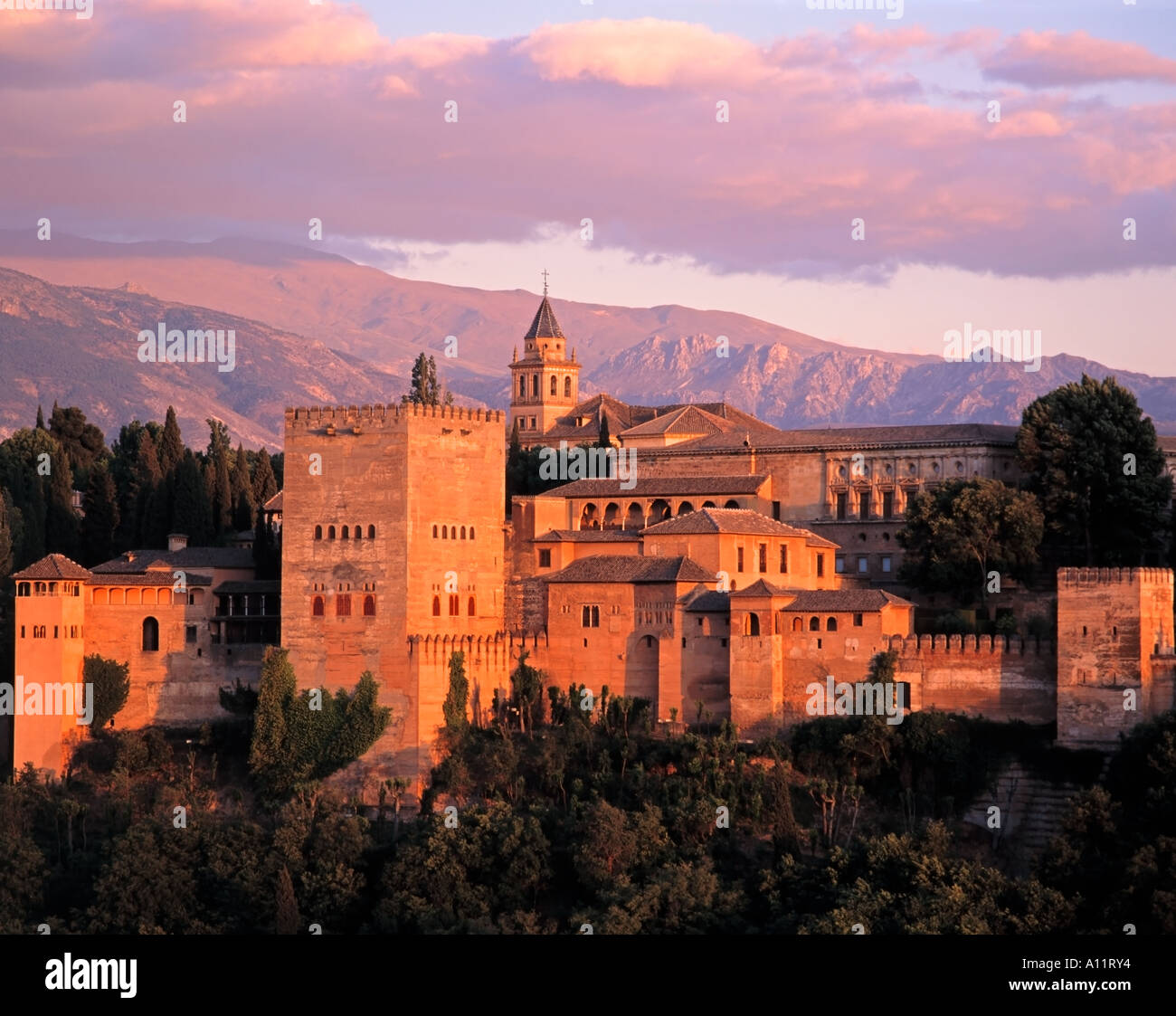 Alhambra at dusk with the Pico de Veleta in the Sierra Nevada Mountain range in the distance, Granada, Andalusia, Spain Stock Photo