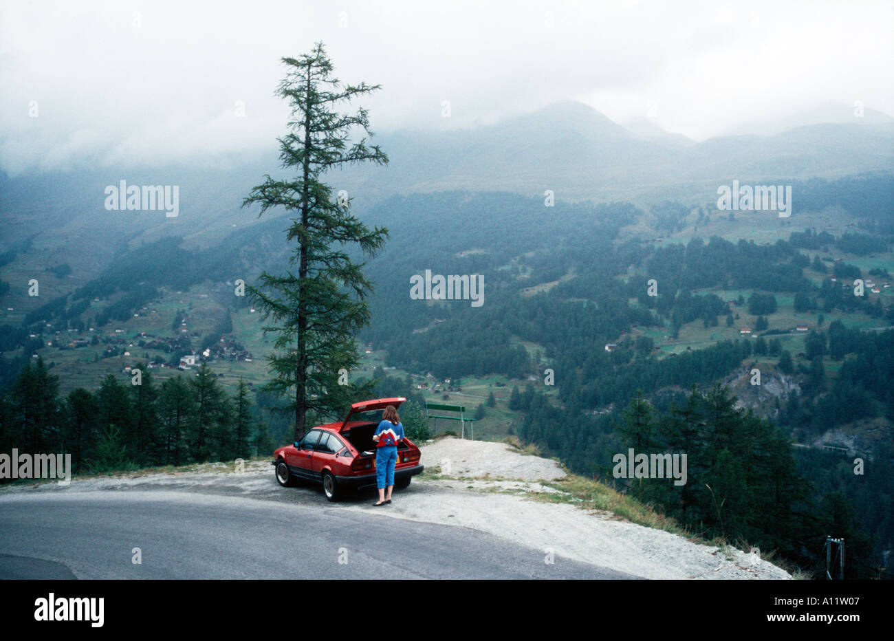 Alfa Romeo GTV6 parked overlooking the Rhone Valley near Nendaz Switzerland on a cloudy day Stock Photo