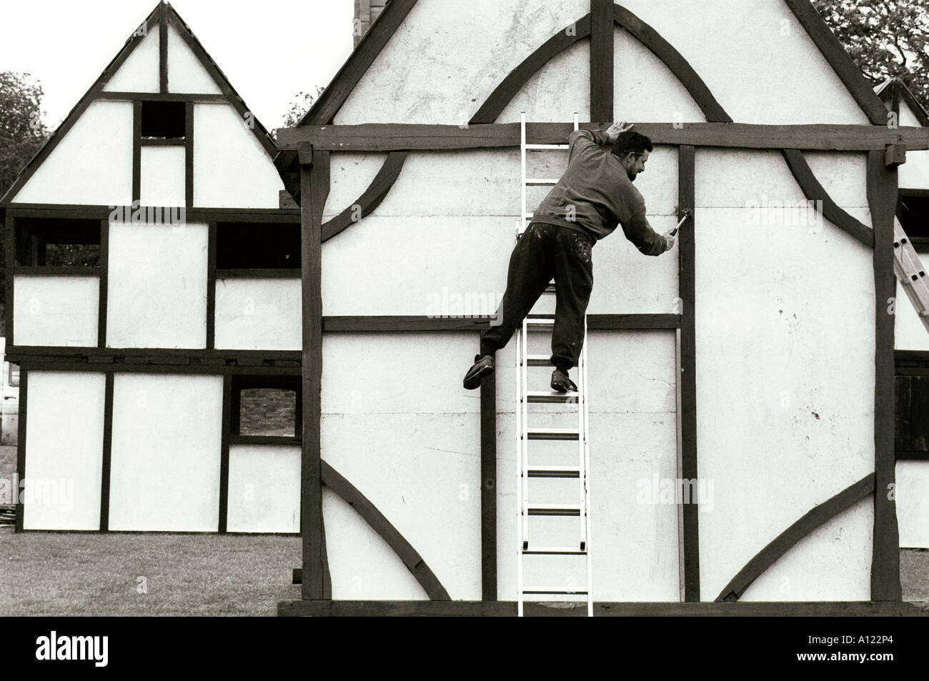 Workman constructing mock tudor cottages at Oakham UK Stock Photo