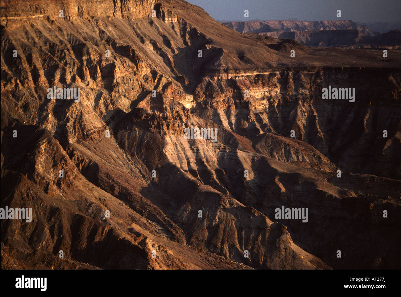 Namibia Cliffs Sunset lights up the steep cliffs of the Fish River Canyon in Namibia ...