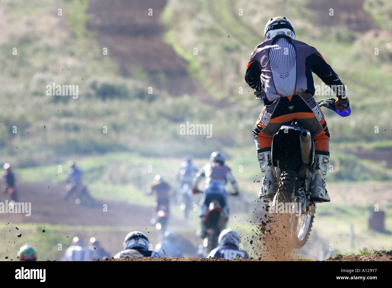 Rider throws up mud and dirt going over earth jump during race at tandragee motocross circuit county down northern ireland Stock Photo
