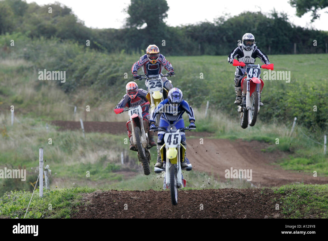riders going over jumps during motocross race at tandragee motocross circuit county down northern ireland Stock Photo