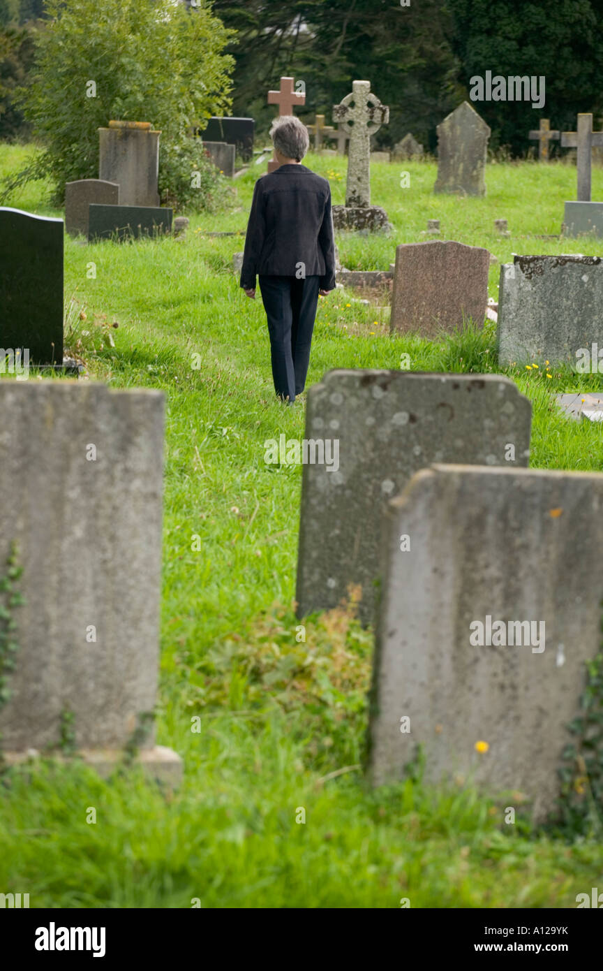 Woman Walking Through Cemetery Woman Walking Through Cemetery