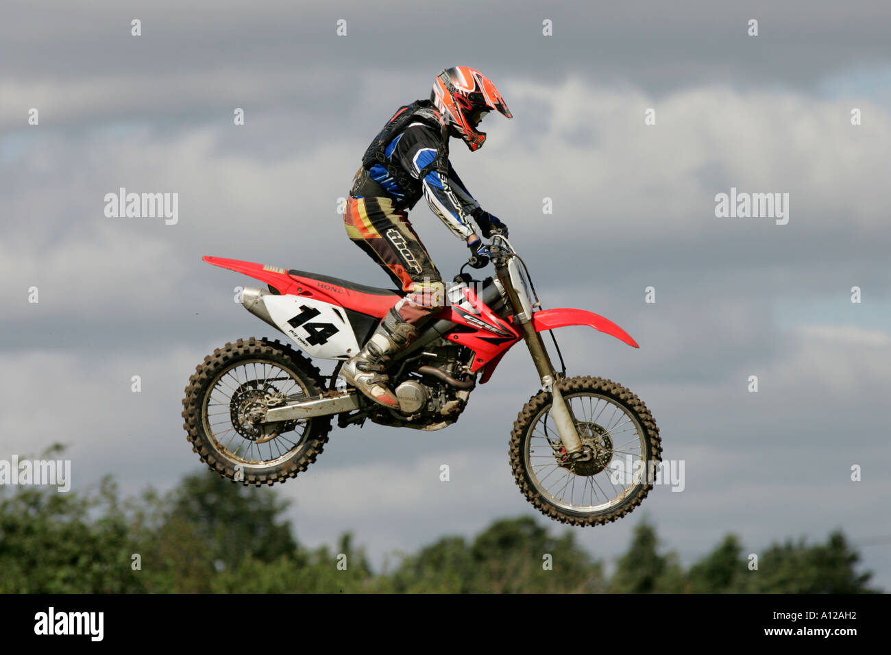 Philip Loughlin 14 jumps his 450 Honda into a cloudy sky at tandragee motocross circuit county down northern ireland Stock Photo