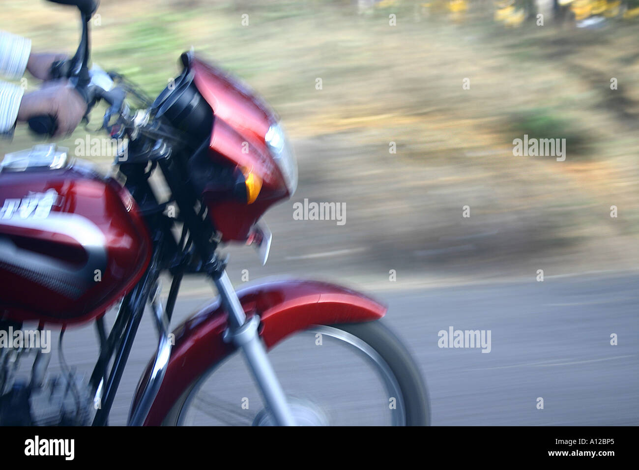 Front wheel of the Red bike TVS speeding on the road National highway Number 3 Nasik Maharashtra India Stock Photo
