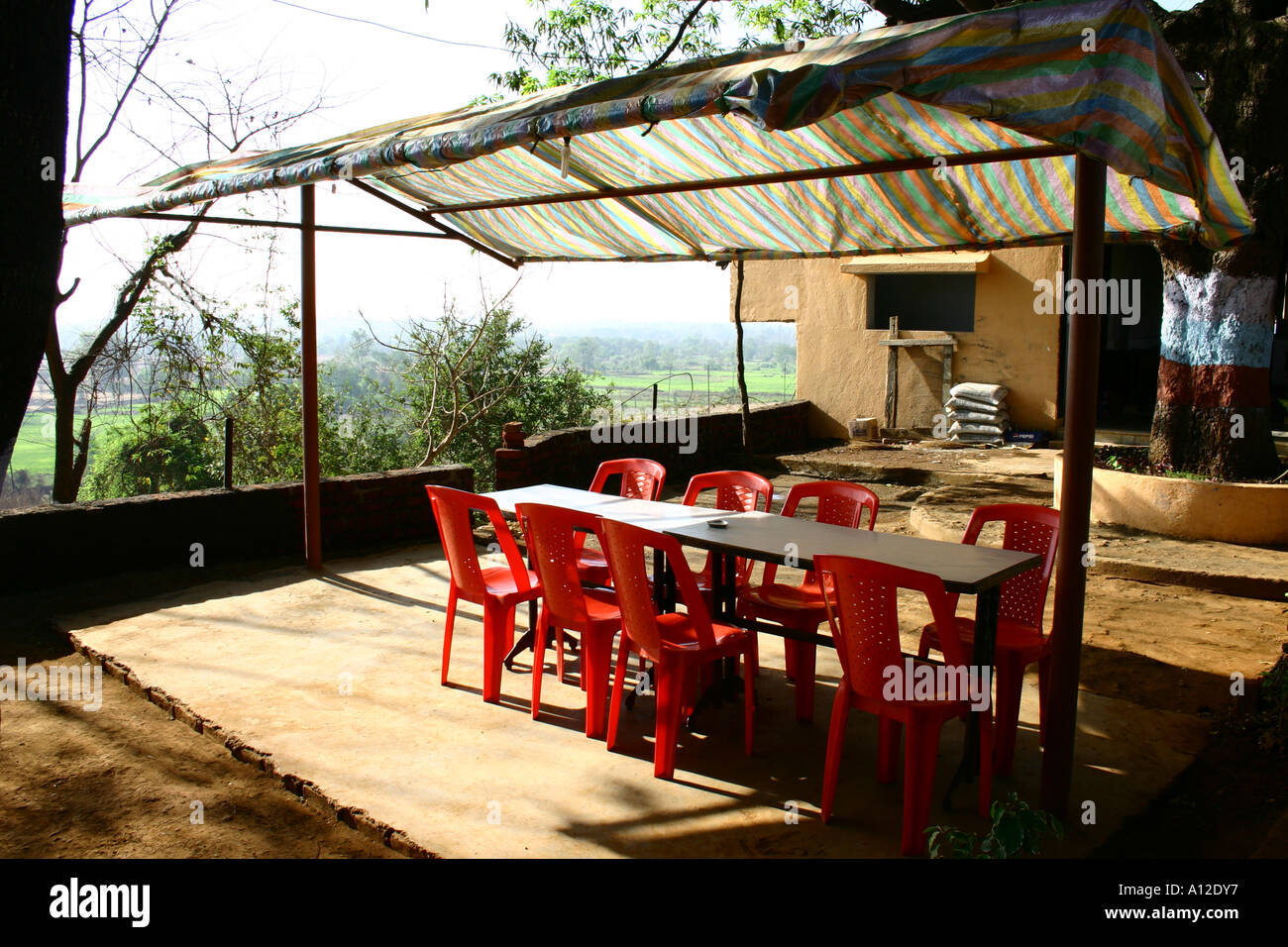 outdoor restaurant with table and eight red plastic chairs, national highway, Maharashtra, India, asia Stock Photo