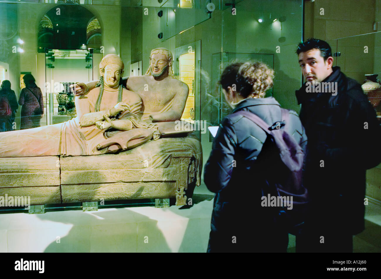 Paris France Couple Visiting in Louvre Museum, 'The Etruscan Sarcophagus of a Married Couple' Sculpture, Statues Stock Photo