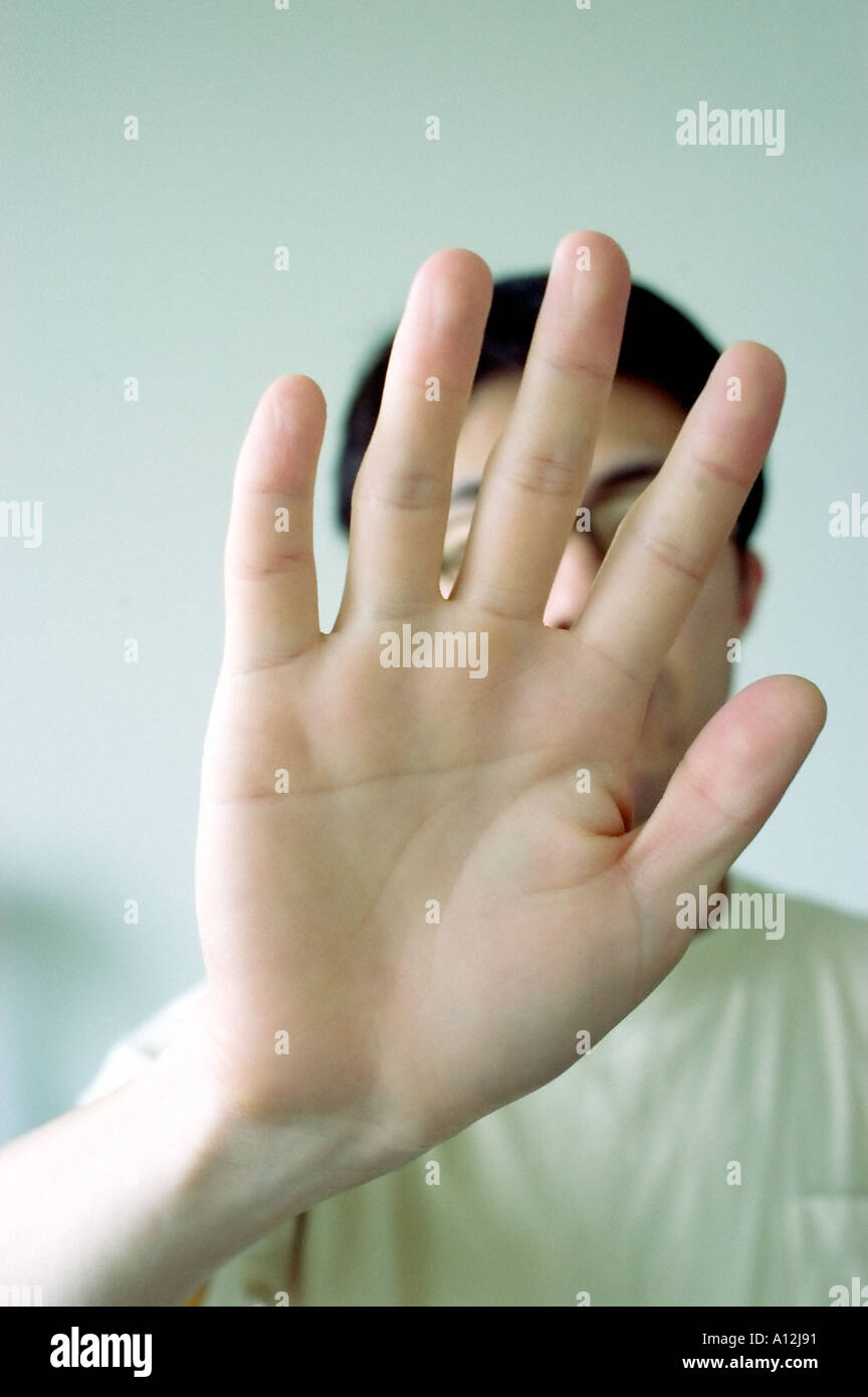 Young Male Adult "Holding hand up" Hand "Gesturing Stop" Stock Photo