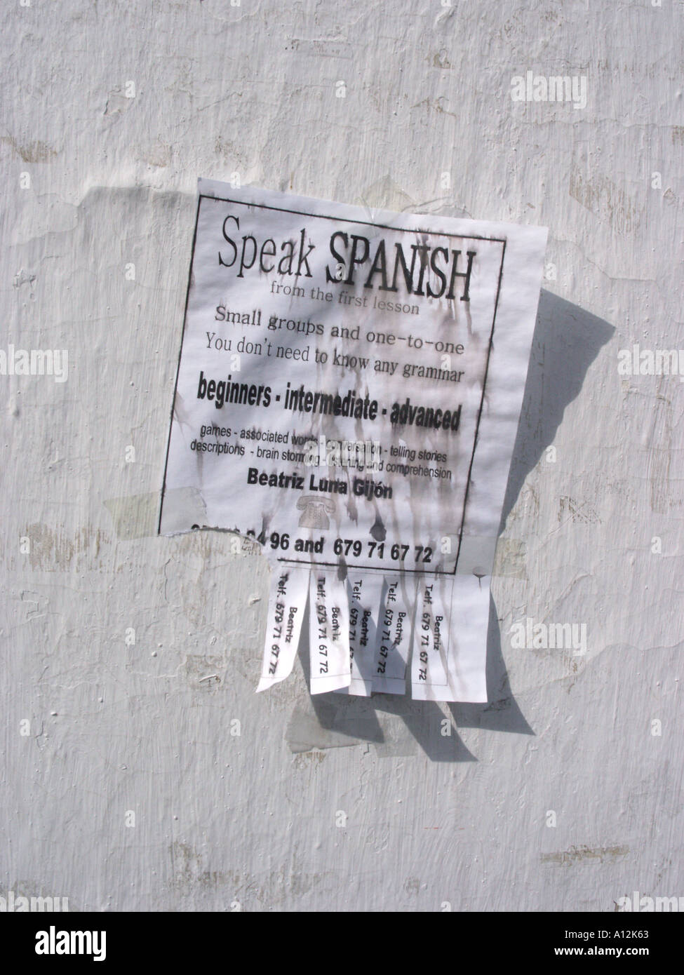 An advertisement for Spanish language classes stuck to a wall in an