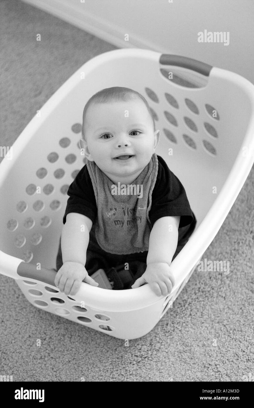 Baby in laundry basket Stock Photo Alamy