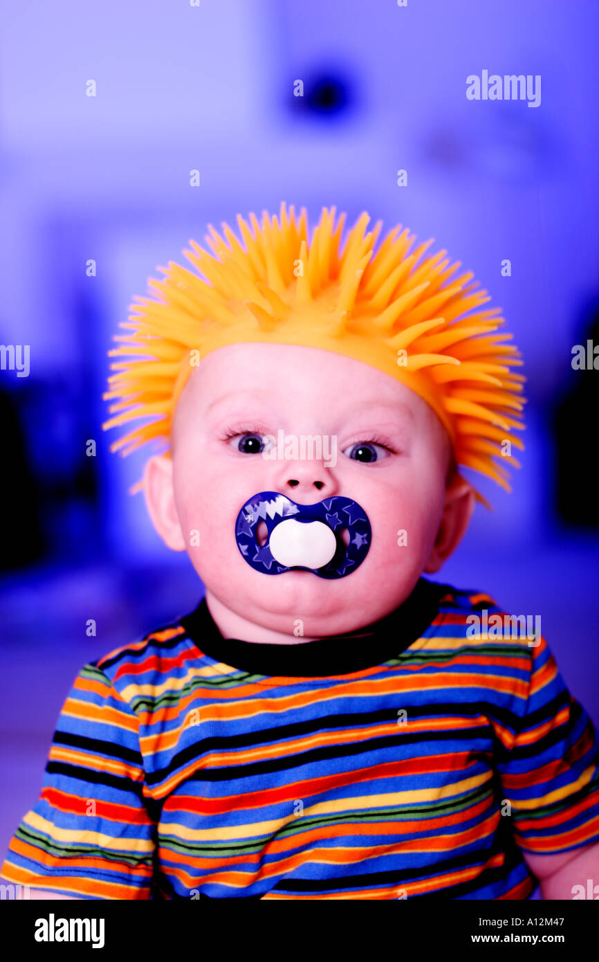 Baby with funny orange wig on his head Stock Photo Alamy