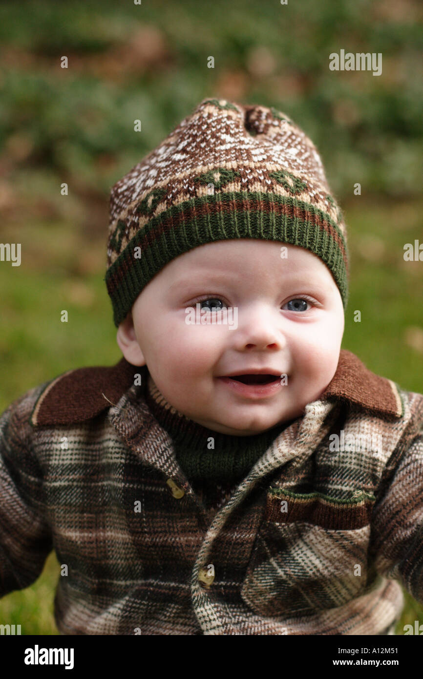 Baby sitting outside in grass Stock Photo