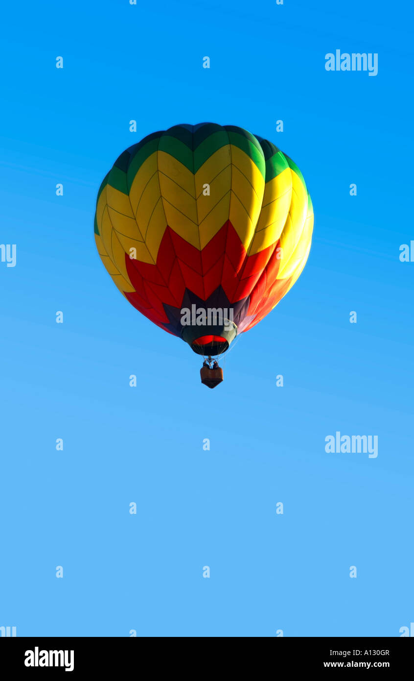 single colorful hot air balloon against a blue sky Stock Photo - Alamy