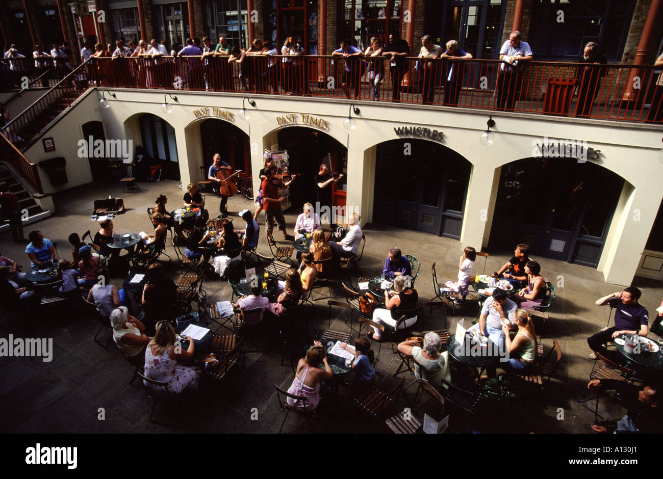 String quartet playing to an audience in an undercover restaurant at