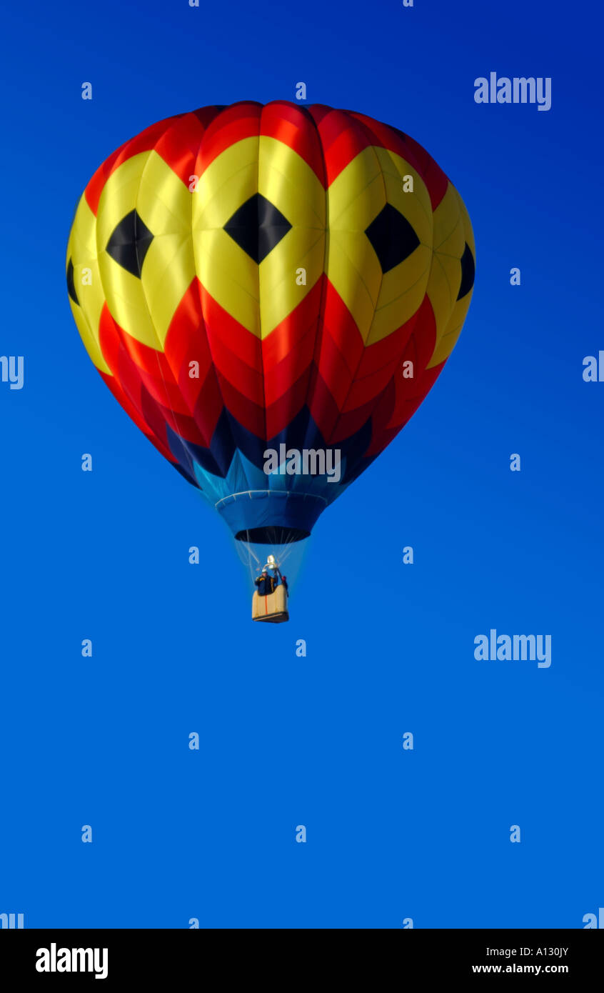 single colorful hot air balloon against a blue sky Stock Photo - Alamy