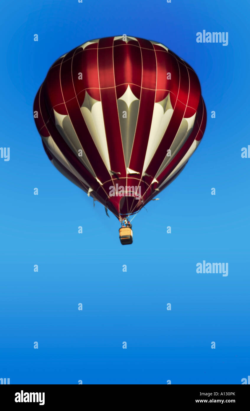 single colorful hot air balloon against a blue sky Stock Photo - Alamy
